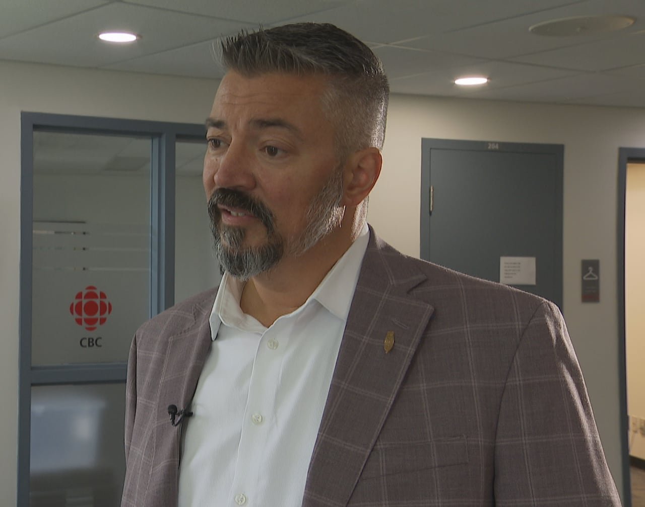 default-826 A man in a suit inside the CBC newsroom.